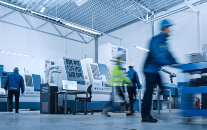Blurred Motion Shot of a Team of Engineers, Professionals and Workers, Working on Assembly and Production Line, Optimizing CNC Machinery, Programming Machines.